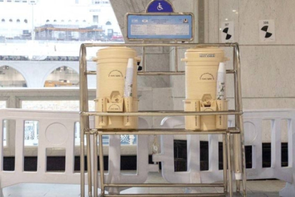 Zamzam water containers at fixed marble stations return to Grand Mosque in Makkah